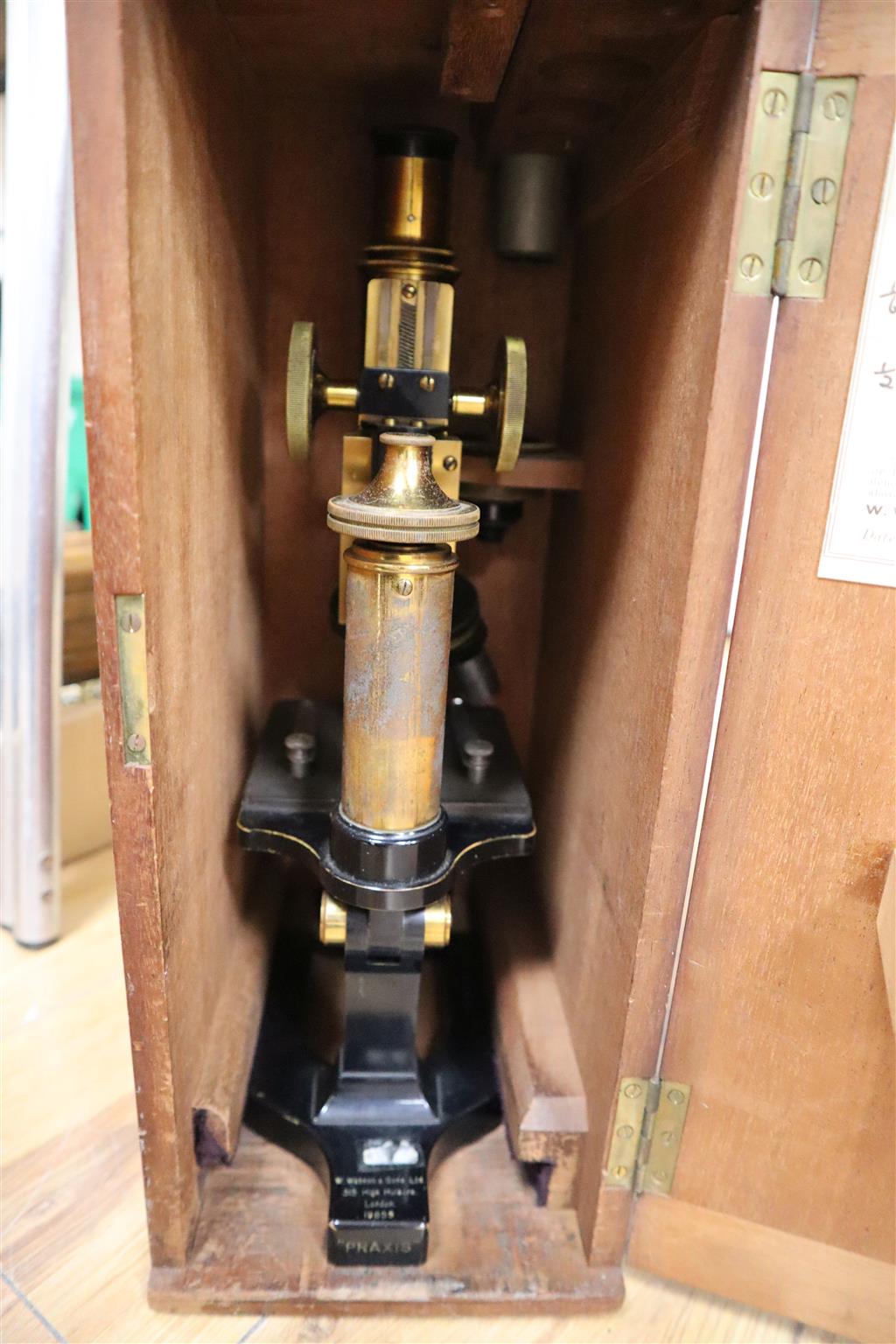 Three various cased microscopes